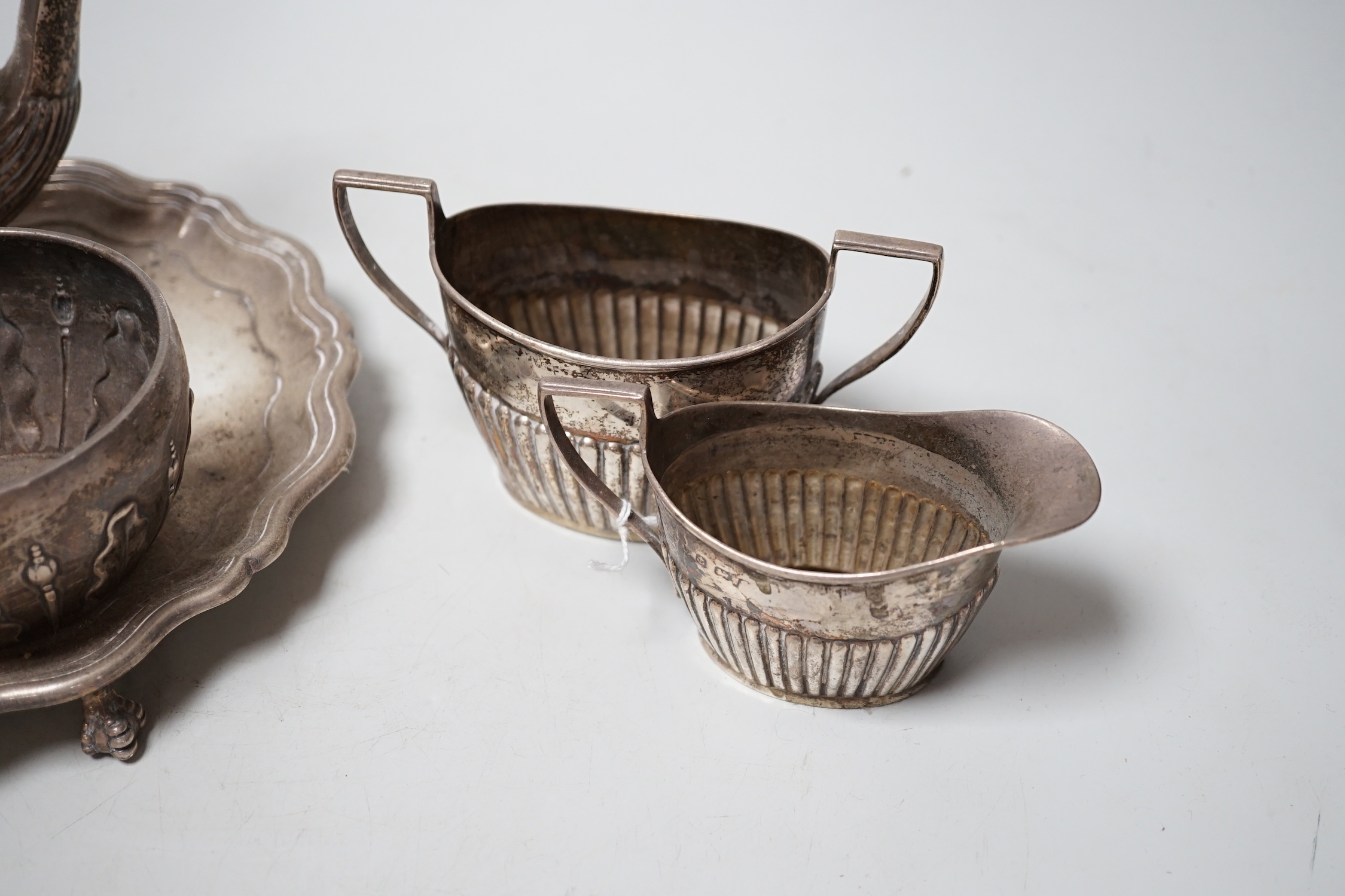 A late Victorian silver sugar bowl, William & John Barnard, London, 1891, a silver three piece bachelor’s tea set and a silver waiter, 27.9oz.